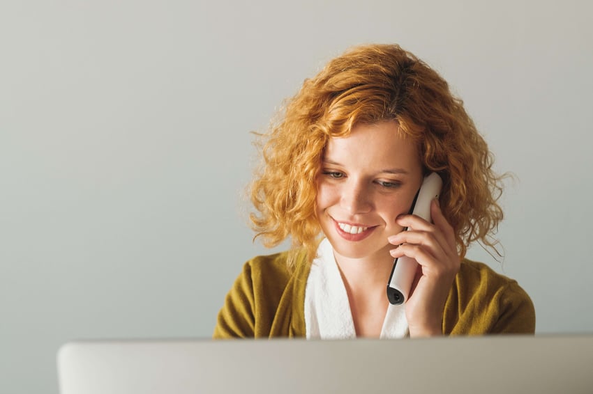  Geschäftsfrau, die im Büro am Telefon spricht