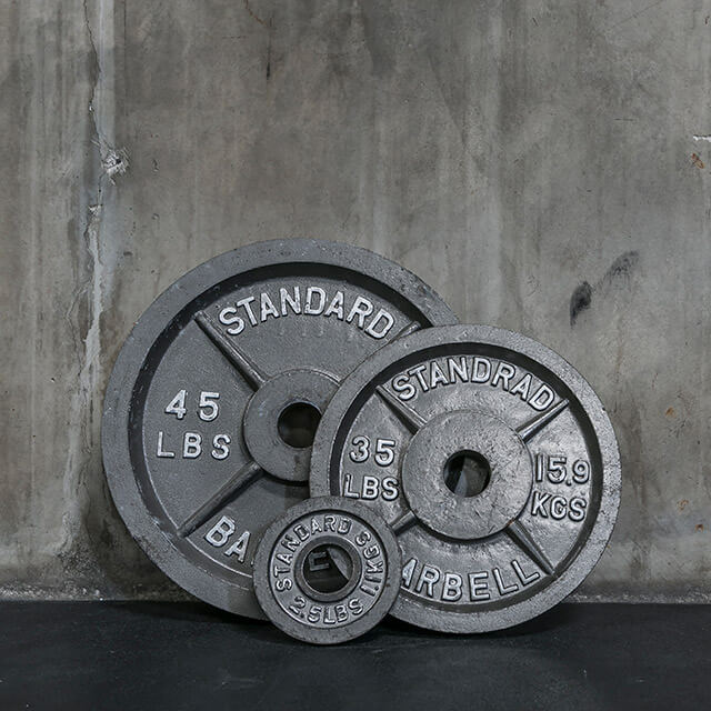 Photograph of three iron weights against wall